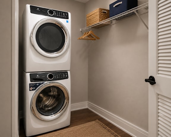 A white front load washer and dryer in a laundry room.