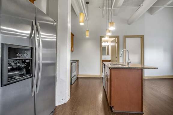 Galley kitchen with island and pendant lights at 100 South Apartments, Buffalo, NY