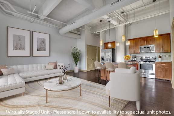 A modern living room with a white sofa and a coffee table.