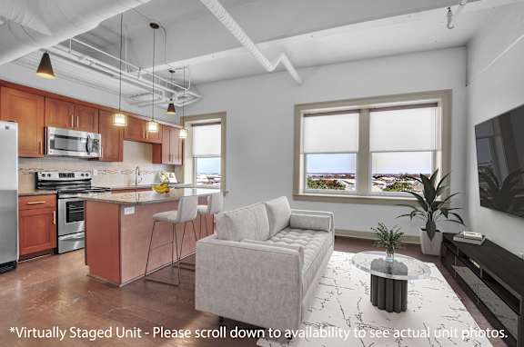 A modern kitchen with a dining area and a living room.