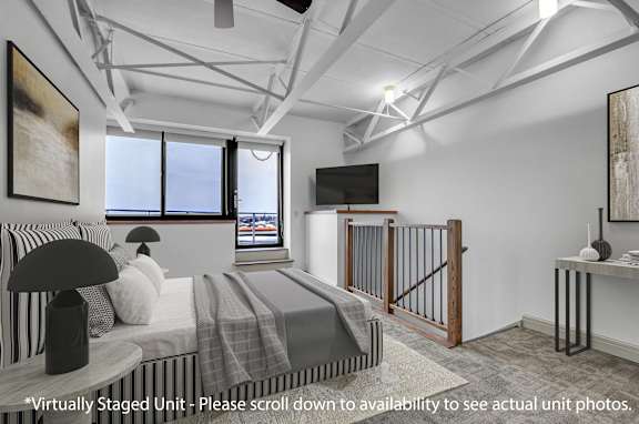 A bedroom with a bed, a television, and a painting on the wall.