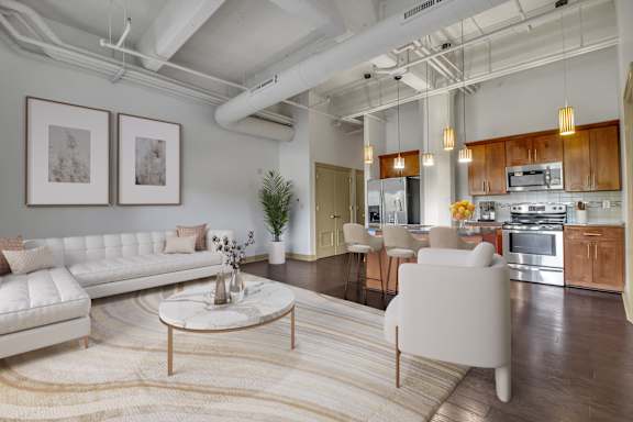 Floor Plan  a living room with a white couch and a table at 100 South Apartments, Buffalo, New York