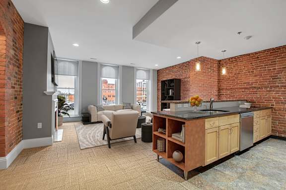 A kitchen with a brick wall and a counter top.