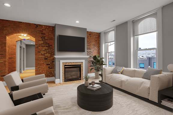 A living room with a fireplace and a flat screen TV mounted on the wall.