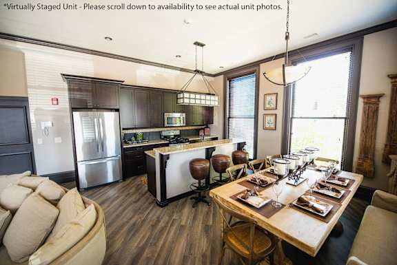 A modern kitchen with a dining table set for six at The Knights @ 506 Delaware Apartments, Buffalo, New York