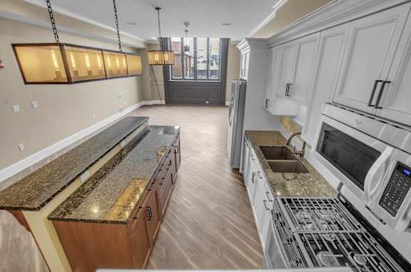 A kitchen with granite countertops and stainless steel appliances.