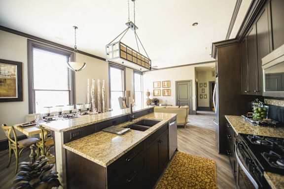 A kitchen with a large island and a dining table.