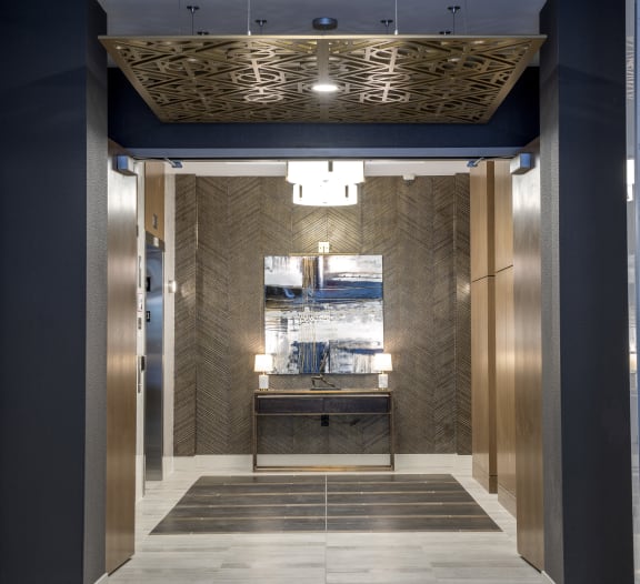 a view of the elevator lobby of a building with a blue and gold elevator lobby at Nineteen North, Buffalo, NY