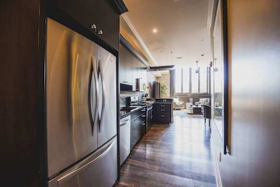 A modern kitchen with a stainless steel refrigerator.