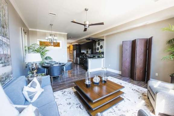 A living room with a blue couch and a wooden coffee table.