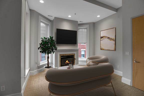 A living room with a fireplace and a large couch.