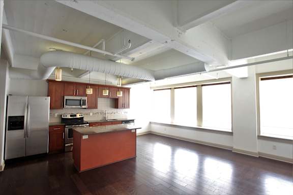 A kitchen with a refrigerator, stove, and microwave at 100 South Apartments, Buffalo