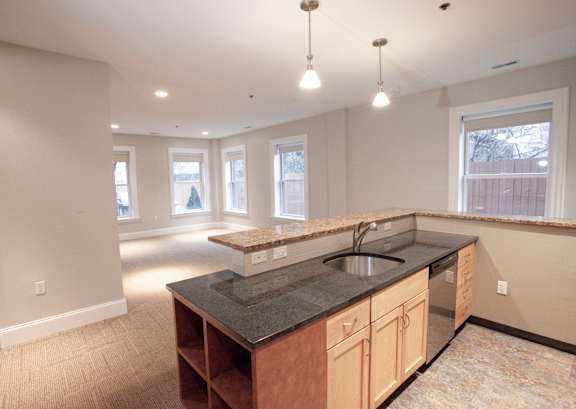 Floor Plan  A kitchen with a black granite countertop and wooden cabinets at The Granite Works Apartments , Buffalo, NY, 14202