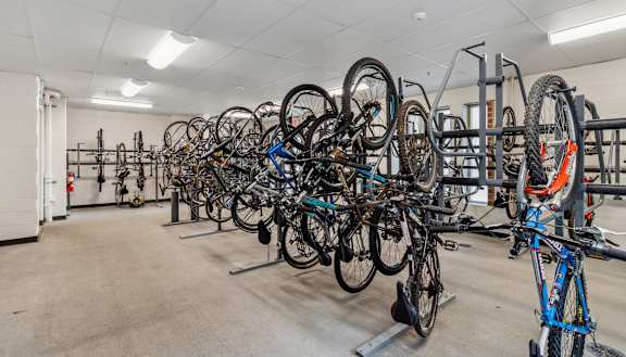 a row of bikes hanging up on racks in a room Hot Metal Flats apartments, Southside Pittsburgh, PA
