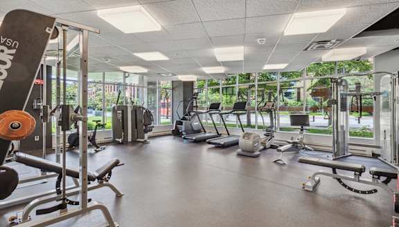 a gym with cardio equipment and windows in a building Hot Metal Flats apartments, Southside Pittsburgh, PA