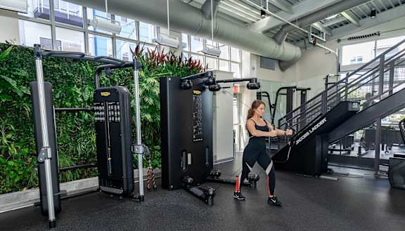 a woman is running on a treadmill in a gym at Bakery Living, Shadyside, Pittsburgh, PA 15206