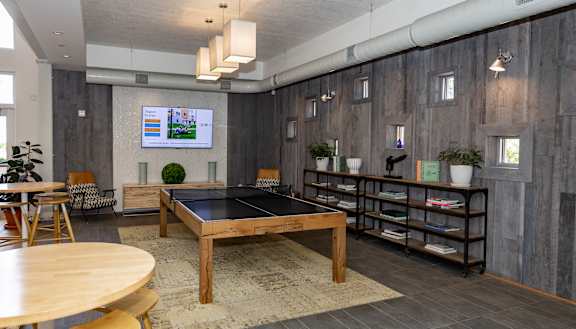 a game room with a ping pong table and a flat screen tv at Bakery Living, Shadyside, Pittsburgh, PA 15206