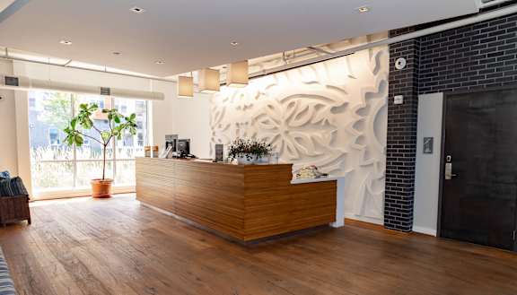 a view of the reception desk with a large mural on the wall behind it at Bakery Living, Shadyside, Pittsburgh, PA 15206