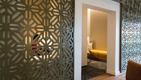 a room with a door that has been decorated with a laser cut screen at Bakery Living, Shadyside, Pittsburgh, PA 15206