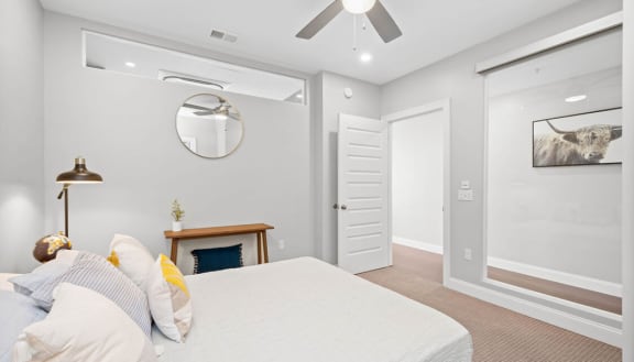 a bedroom with grey walls and a white bed at The Washington at Chatham, Pittsburgh, PA