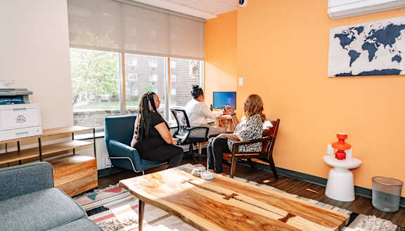 a group of people sitting at a table in a room with a large window  at Walnut Crossings, Monroeville, PA, 15146