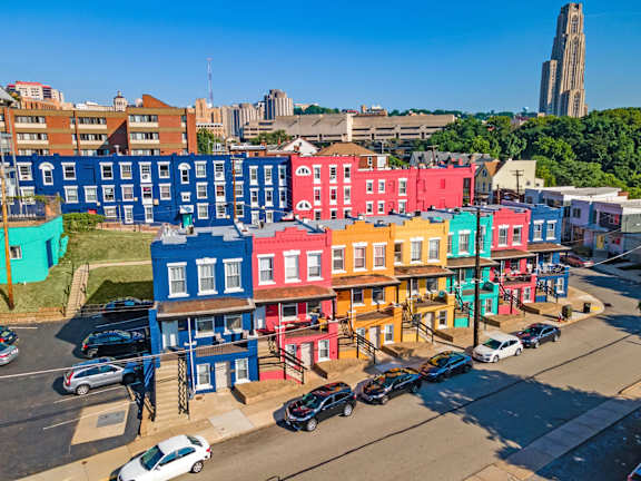 A row of colorful buildings are seen from an aerial perspective.