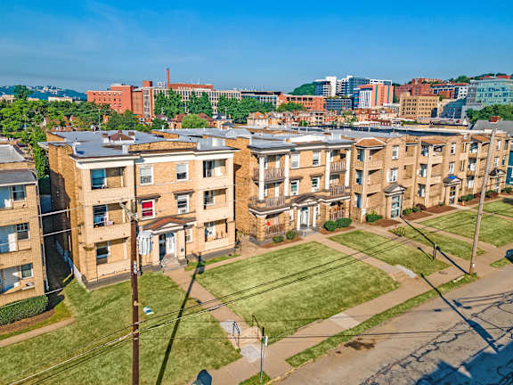 Apartment complex with a green lawn in front.