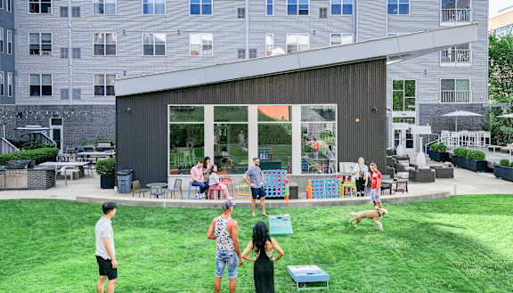 a group of people standing on top of a lush green field at Bakery Living, Shadyside, Pittsburgh, PA 15206