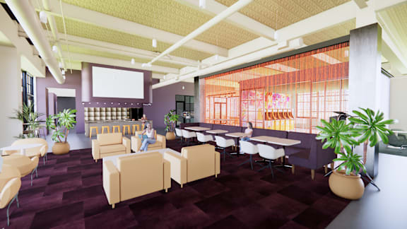 A woman is sitting on a chair in a room with purple carpeting.