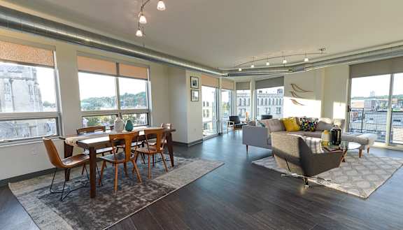 an open living room and dining room with a view of the city