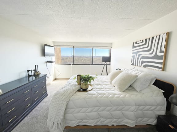 a bedroom with a large bed and a dresser at Walnut Towers at Frick Park, Pittsburgh, PA