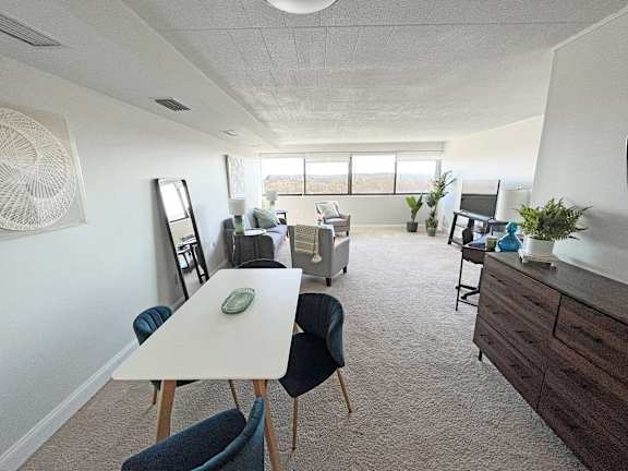 an open living room and dining room with a white table and chairs at Walnut Towers at Frick Park, Pittsburgh