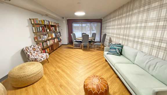 a living room with a couch a table and chairs and a bookshelf at Walnut Crossings, Monroeville, PA, 15146