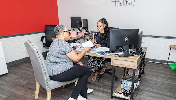 two women sitting at a desk in front of a computer at Walnut Crossings, Monroeville, PA, 15146