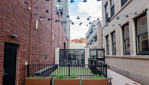 a courtyard with a grassy area and a black gate at Walnut on Highland, Pennsylvania 15206