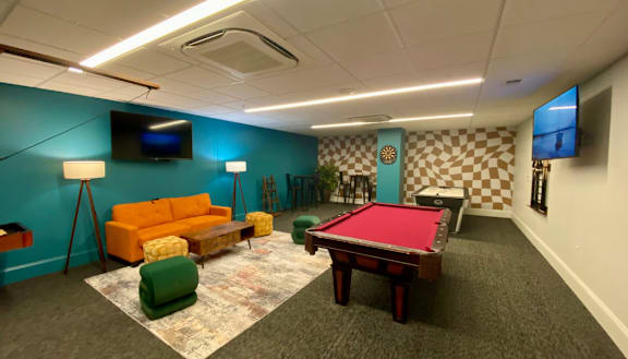a game room with a pool table and a tv at The Washington at Chatham, Pittsburgh, PA 15219