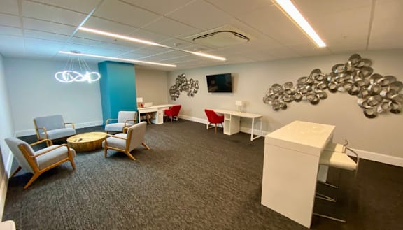 a meeting room with chairs and a table and a wall with a cluster of spheres at The Washington at Chatham, Pittsburgh, PA 15219