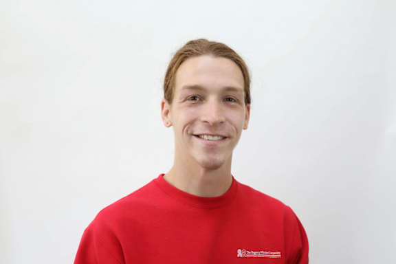 A man in a red shirt with a logo on it.