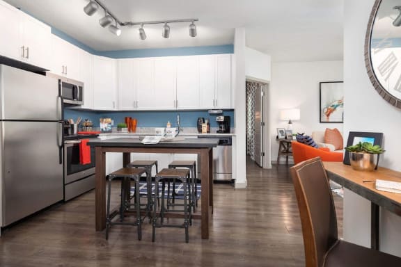 White cabinets, wooden dining at Solara Apartments, Sanford, FL, 32771