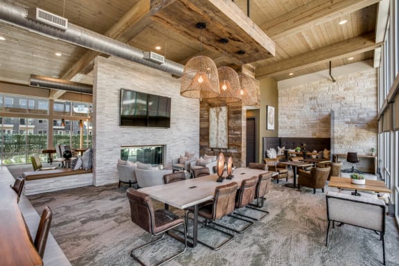 a large living room with a large table and chairs and a fireplace at Trailhead, Austin, TX