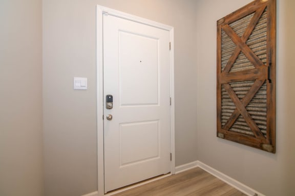 a white door in a room with a wall art at Jackson Run Townhomes, Indiana