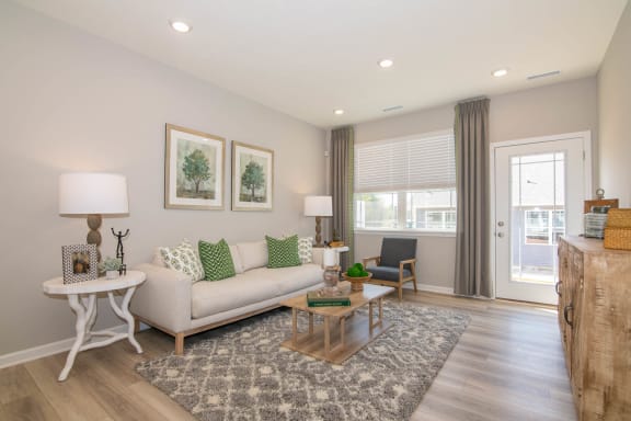 a living room with a couch and a table at Jackson Run Townhomes, Whitestown, IN 46075
