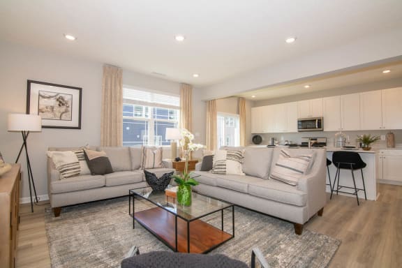 a living room with two couches and a coffee table at Jackson Run Townhomes, Whitestown, IN 46075