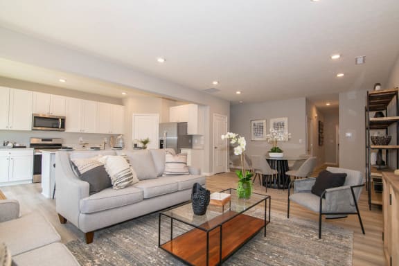a living room with a couch and a table at Jackson Run Townhomes, Whitestown, IN 46075