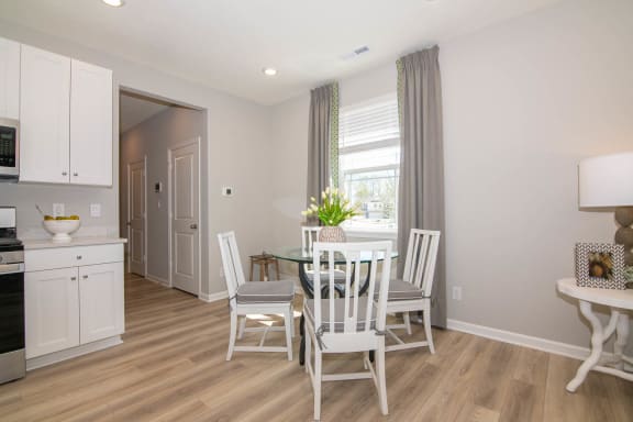 a kitchen and dining room with a table and chairs at Jackson Run Townhomes, Whitestown, 46075