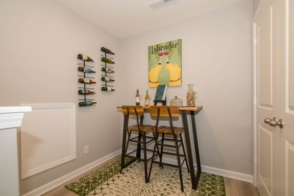 stairway with bar and stools at the top of the stairs at Jackson Run Townhomes, Indiana