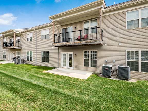 A residential building with a balcony and two air conditioning units. at River View at Bexley Apartments, Ohio, 43209