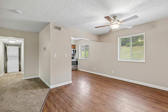 A room with a ceiling fan and a window.