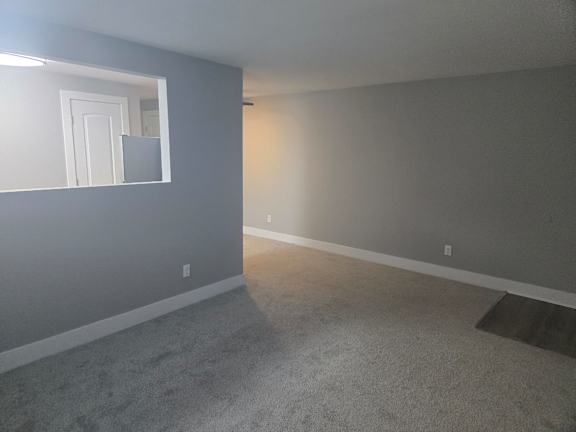 A room with grey walls and carpet.