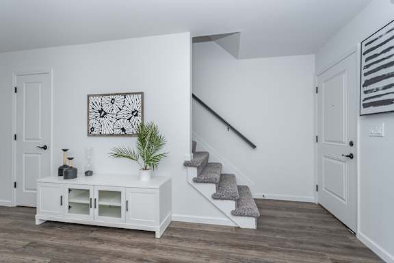 A white room with a staircase and a cabinet. at Ten31, Dayton, OH, 45458